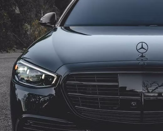 Close-up of the corrected, ceramic-coated black paint and headlight on a Mercedes-AMG S63 by Monarch